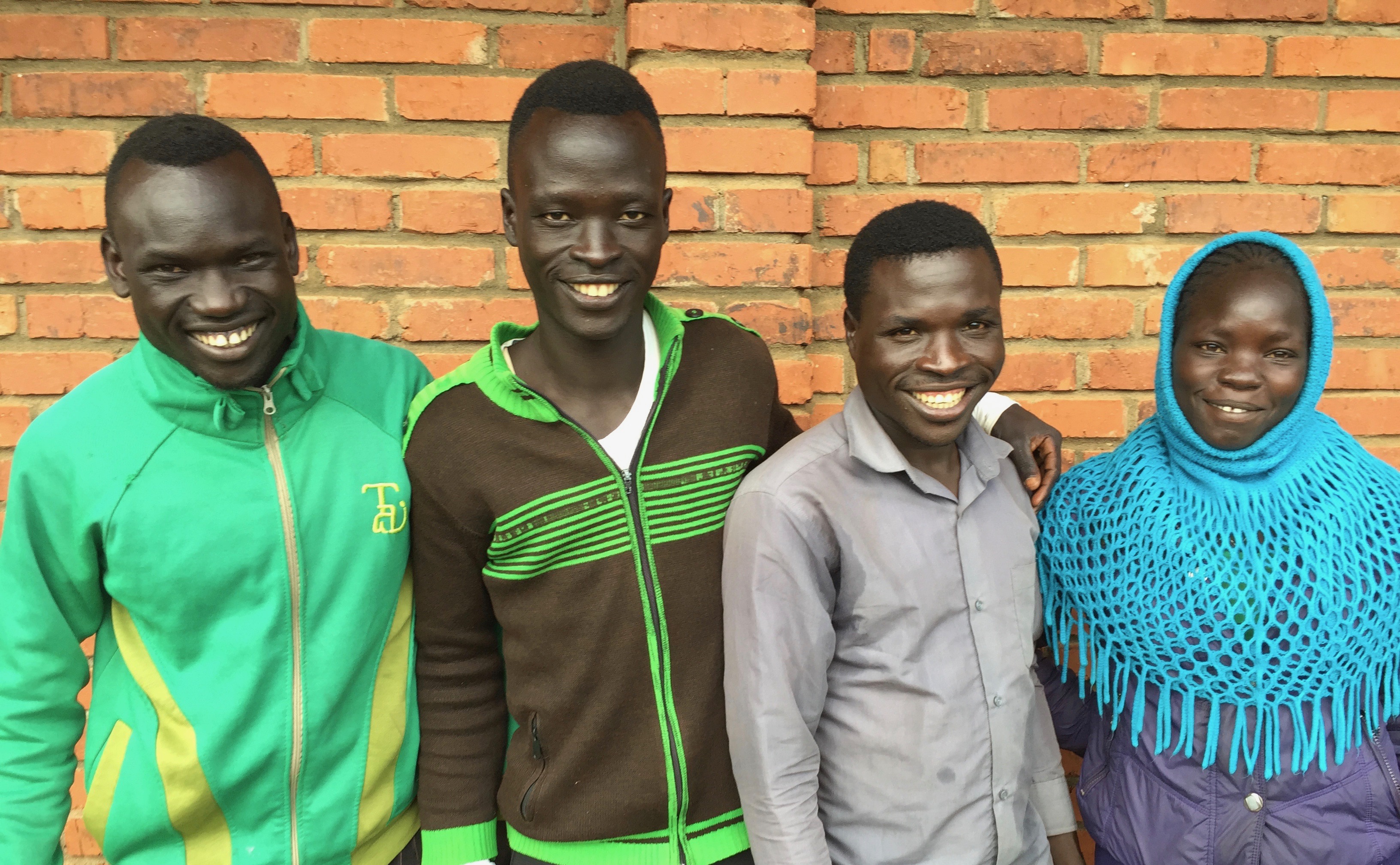 A group of people standing togetherAI-generated content may be incorrect.